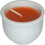 Set of 6 orange candles in white ceramic dish