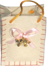 White felt bag with cord handles and brass bells