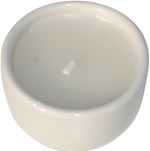 Single white candle in white ceramic cup