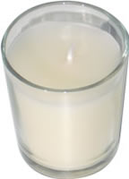 White candle in glass cup 